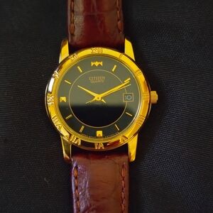 Citizen Women's Gold and Black Watch with Brown Leather Strap.